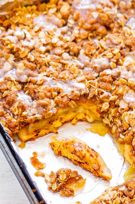 baking tray of cinnamon roll apple bake with a slice missing